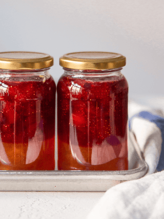 Two glass jars filled two coloured Jams made with Tate & Lyle Jam Sugar