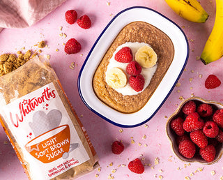Bag of Light Soft Brown sugar laid next to a tray of Breakfast Oat