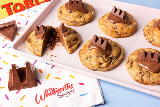 A tray of chocolate chip cookies with a gooey chocolate nougat and almond centre.