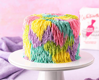 A shaggy cake iced using the grass piping nozzle to create a funky retro effect