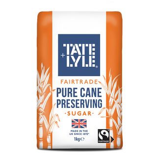 A 1kg bag of Tate Lyle Fairtrade Pure Cane Preserving Sugar, featuring orange side panels, a white center, and a prominent blue brand logo.
