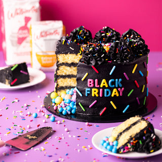 Black Friday cake with colorful sprinkles on a purple table