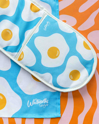 Oven glove with fried egg pattern on a colourful background