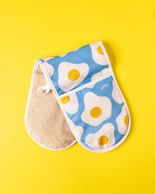 Pair of oven mitts with egg pattern on a yellow background