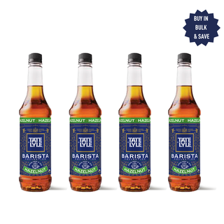 Four bottles of Tate & Lyle Barista Hazelnut syrup on a white background