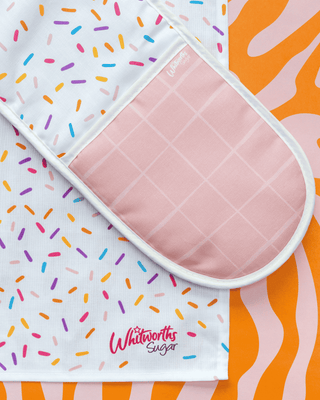 Flat lay of Sprinkles Tea Towel and Oven Glove