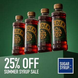 Four bottles of Elden Sugar-Free Peach Syrup arranged on a green pedestal with a dark green background. Large promotional text at the bottom reads '25% OFF SUMMER SYRUP SALE,' and a blue badge in the lower right says 'SUGAR SYRUP.