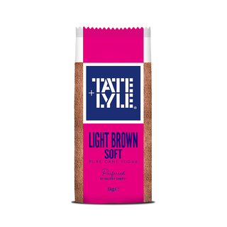A 3kg bag of Tate & Lyle Light Brown Soft Puree Cane Sugar, featuring a bright pink and navy blue label with the brand logo and product details, set against a plain white background.